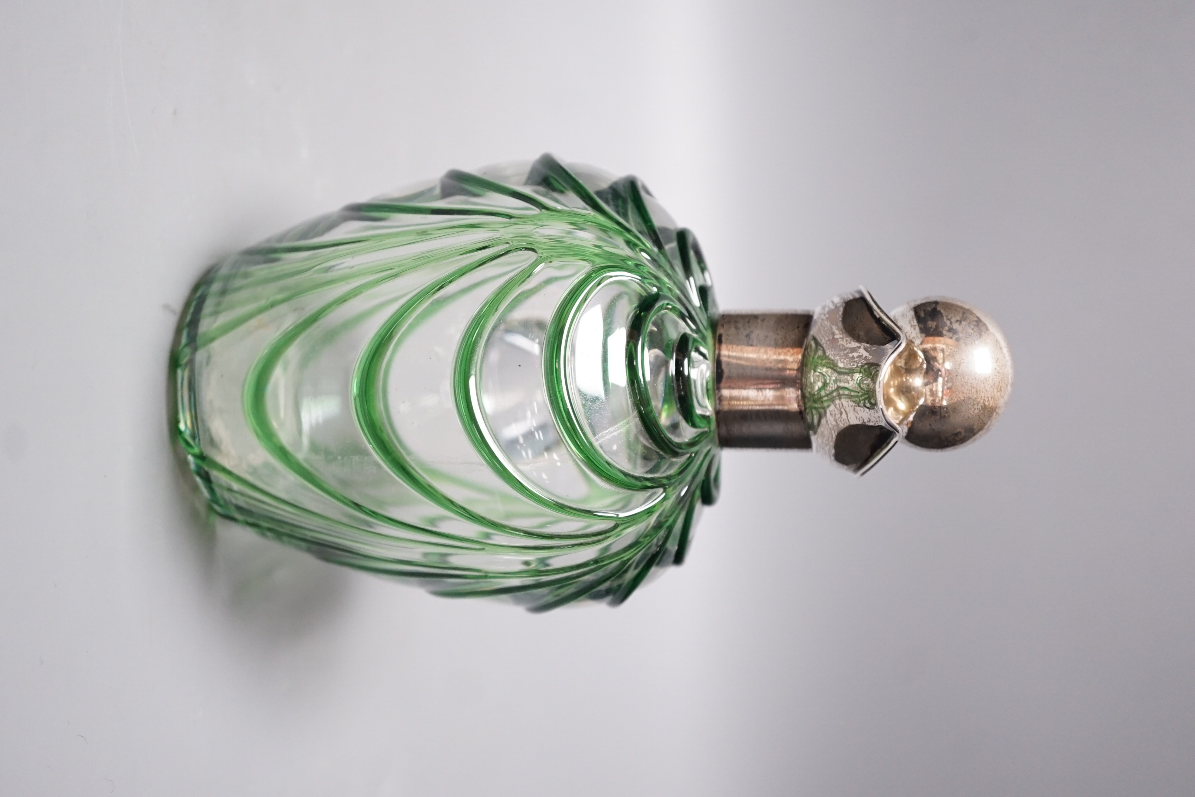 A late Victorian Art Nouveau silver mounted glass claret jug and stopper, D & M Davis, Birmingham, 1900, the glass with ribbed green swags, height 20.7cm.